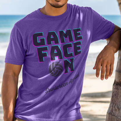 Person wearing a purple t-shirt with 'GAME FACE ON' text and volleyball graphic on a beach.